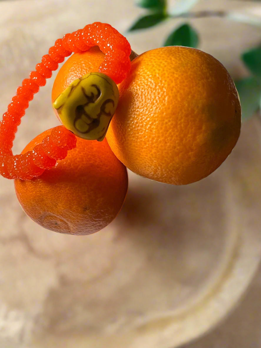 Blood Orange sugar bead bracelet w/ lemon yellow buddha charm